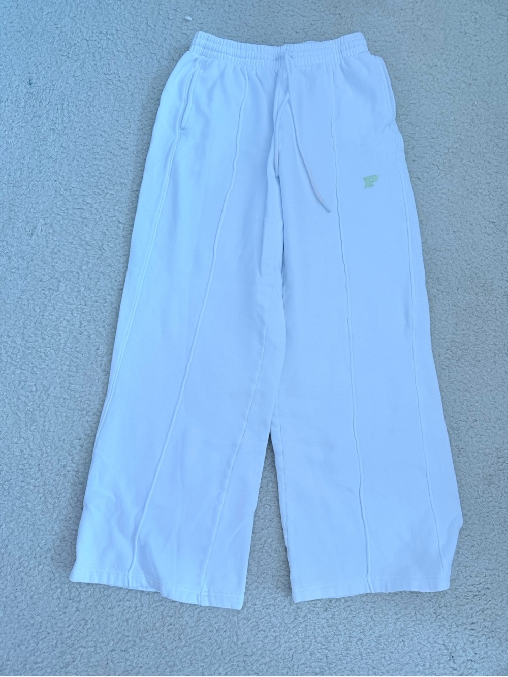 White pink wide leg sweat pants with green logo